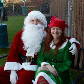 Santa and the elf give toys to shelter pets
