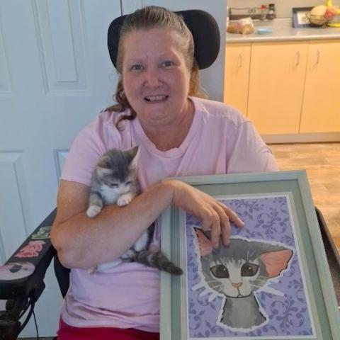 Laverne the kitten with her adopter, Carolyn, and a portrait made by neighbor, Hazel