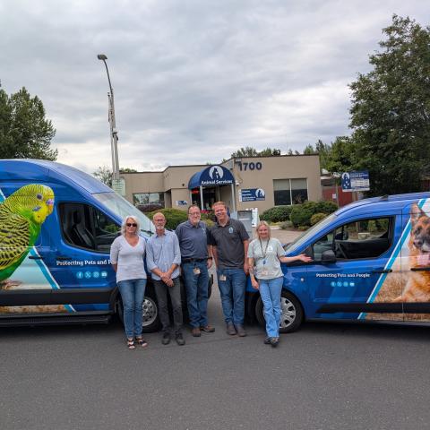 Vans with group in front of the shelter